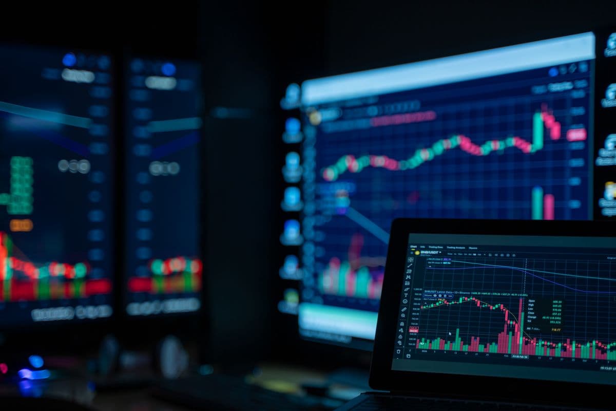 Stock trading charts on screens